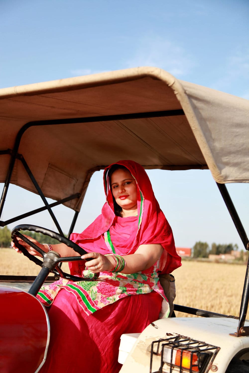 Woman on tractor in field
